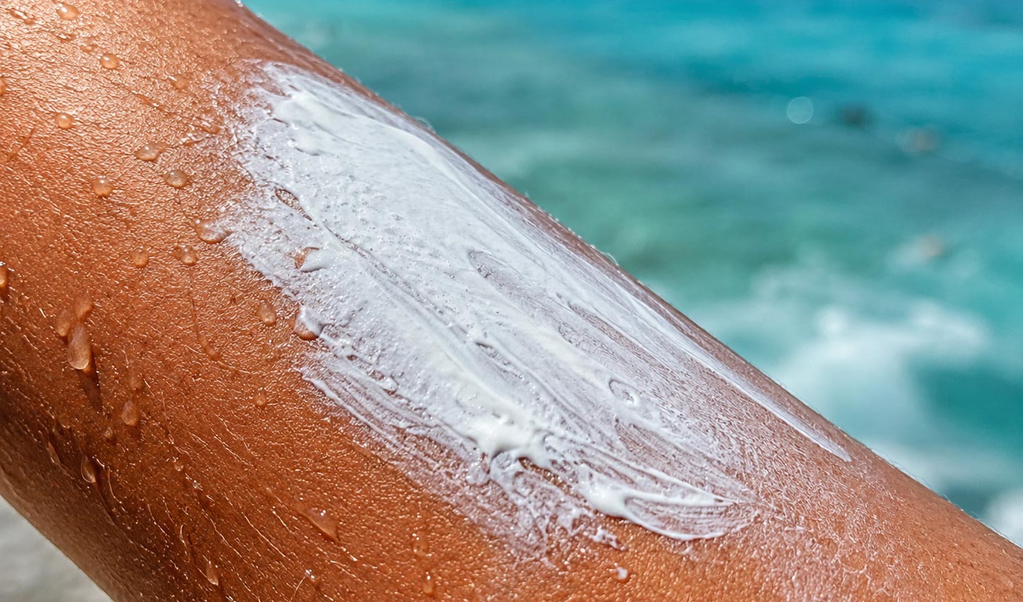 Mineral reef-safe sunblock rubbed onto skin, a light protective layer that is gentle on coral