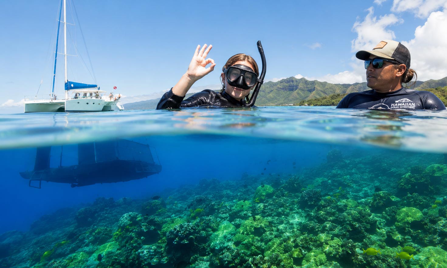 A snorkeler giving an OK hand signal beside a guide in calm, clear Waikiki water above a reef